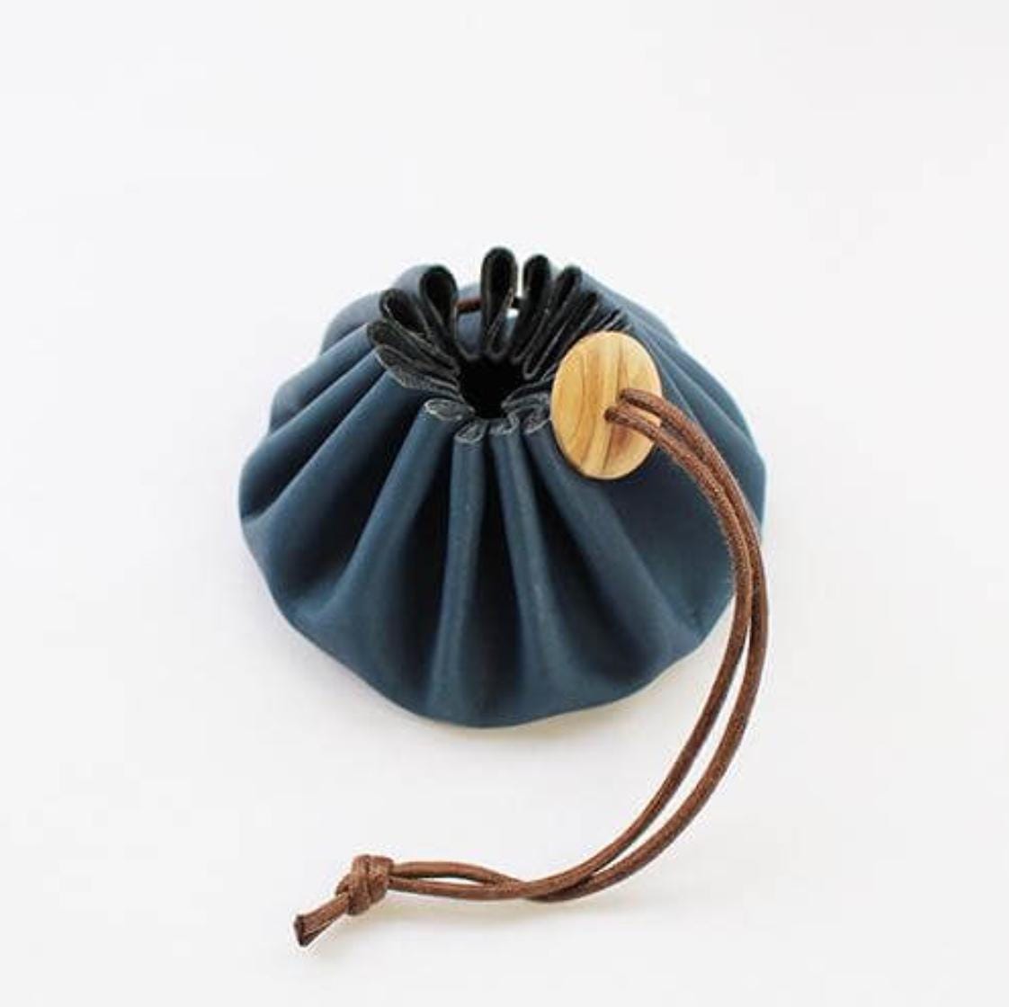 a small blue bag with a wooden handle