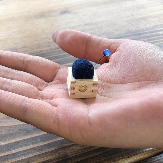 a small toy is sitting on a persons hand