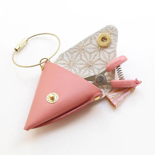 A pink leather keychain with a tassel and a pair of scissors is shown in the image.