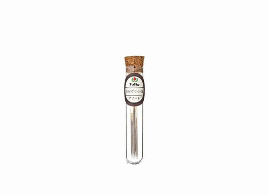 A clear glass tube with a cork stopper, containing a small amount of what appears to be a liquid or powder.