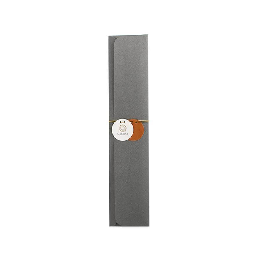 A gray envelope with a white circular tag and orange circles attached to it.