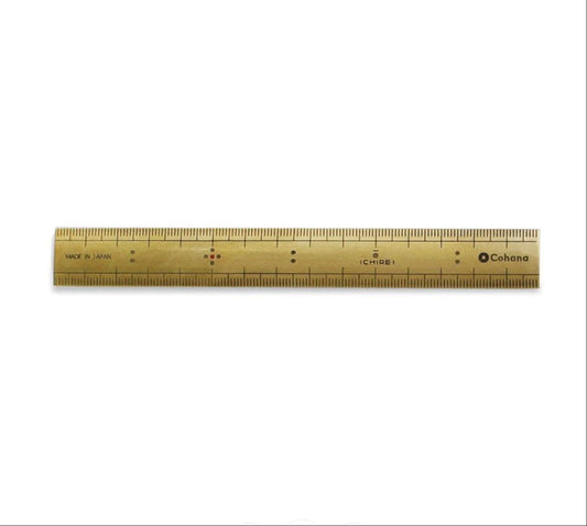A gold-colored ruler with black markings and text, including the brand name "Cohana".