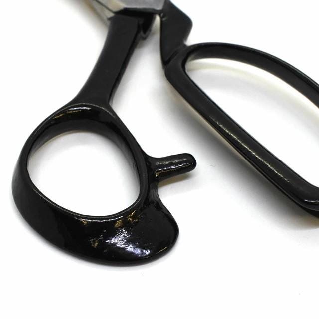 A close-up view of a pair of black scissors with a shiny, reflective surface.