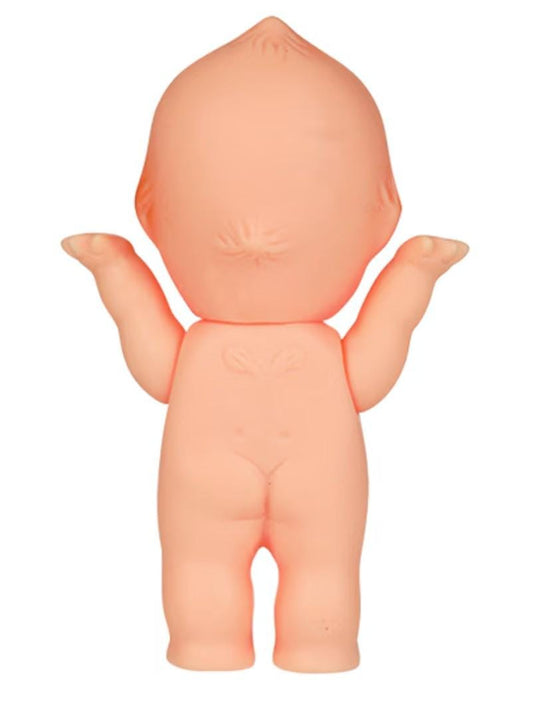 A small, peach-colored plastic toy figure of a baby doll with outstretched arms.