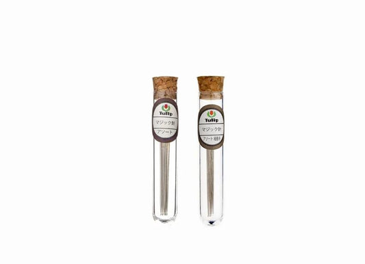 Two glass tubes with cork stoppers, each containing a small amount of liquid, are shown against a white background.