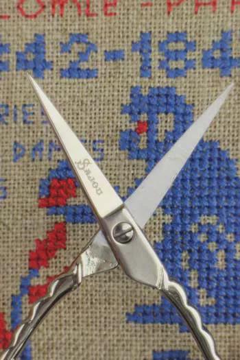 A pair of scissors with a blue and red design on the background.