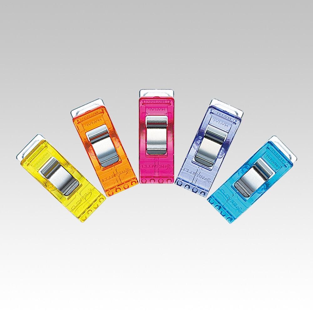 five colorful plastic clips arranged in a fan-like formation against a gray background.