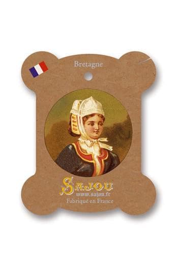 a woman wearing a traditional French outfit, including a white hat and a black dress.