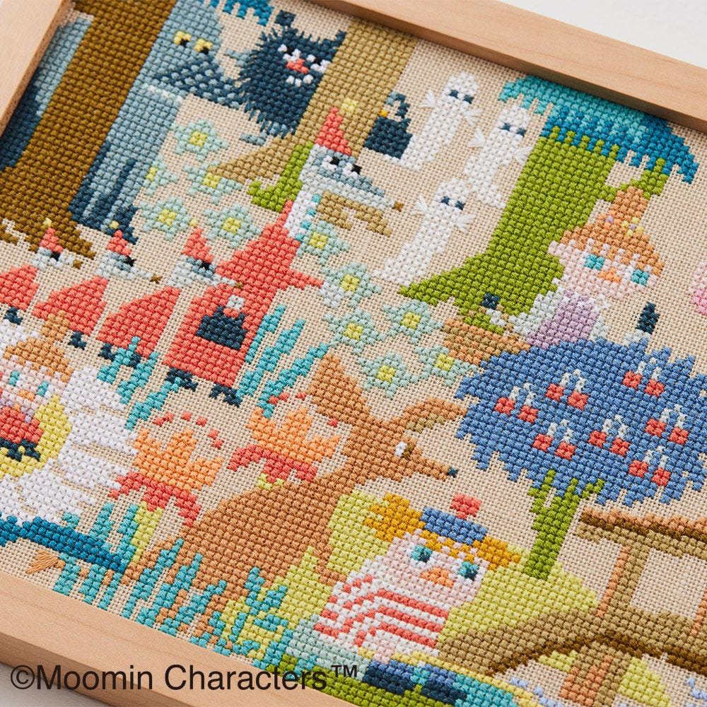 The image is a cross-stitch embroidery depicting various characters and scenes, including animals, people, and objects.