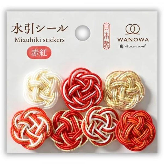 a collection of colorful, intricately woven buttons in red, white, and gold, arranged in a grid pattern.
