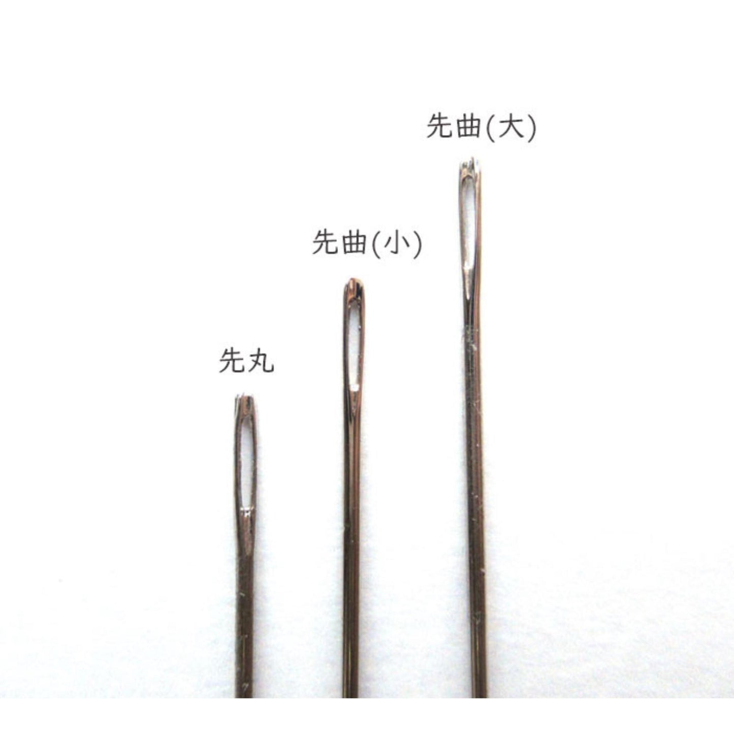 three different types of sewing needles, each with a distinct shape and size, arranged in a row against a white background.