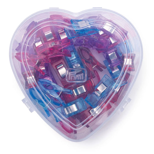 A heart-shaped container filled with a variety of colorful plastic clips in shades of pink, blue, and purple.