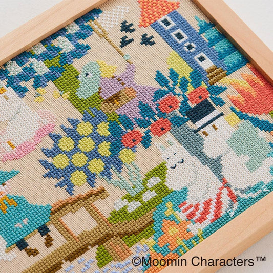 The image is a cross-stitch embroidery depicting various characters and scenes, including a bird, flowers, and a boat.