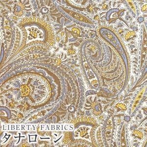 The image is a close-up of a paisley pattern with a mix of yellow, blue, and white colors. The pattern has intricate designs and swirls, creating a visually striking and detailed appearance.