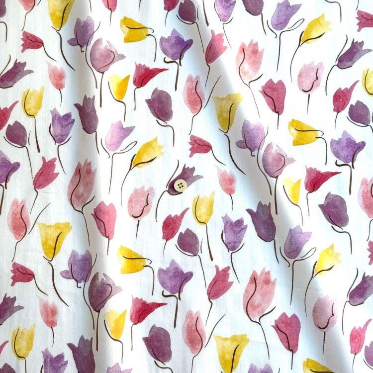 a repeating pattern of colorful watercolor flowers in various shades of pink, yellow, and purple.