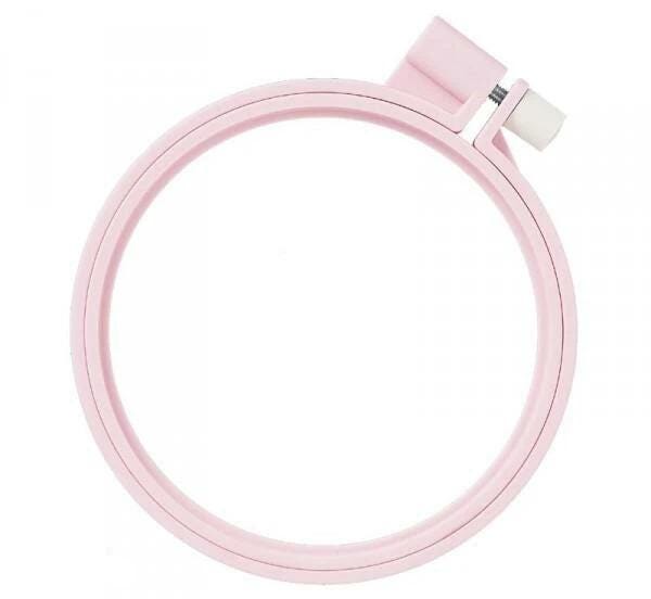 A pink embroidery hoop with a white attachment on the top.