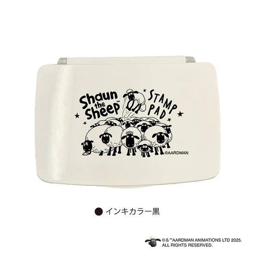 A white object with a black and white illustration of a group of sheep and the text "Shaun the Sheep" printed on it.