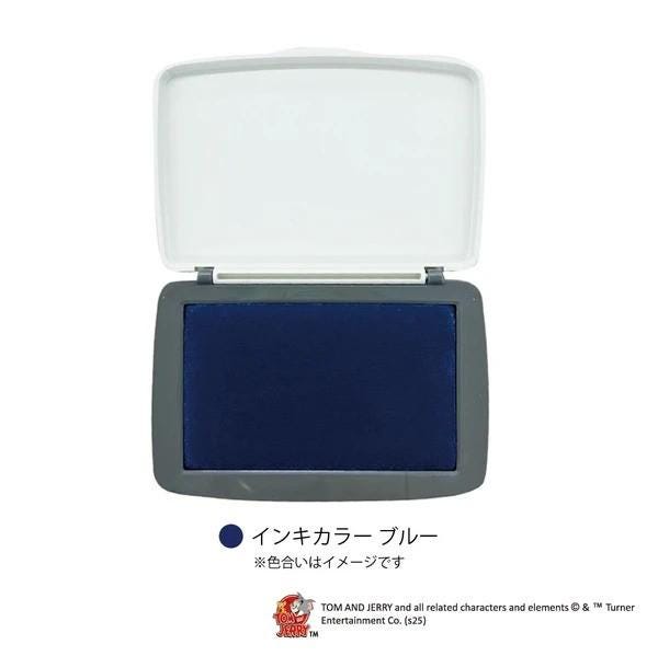 A white stamp with a blue background, placed on a white surface.