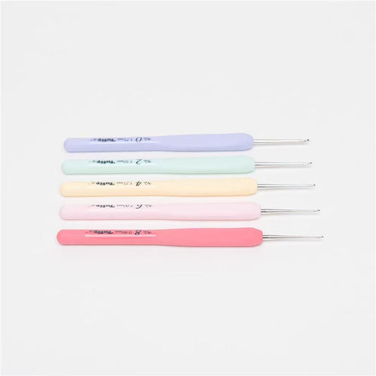 A collection of five crochet hooks in various pastel colors, including pink, light blue, light green, light yellow, and light pink.