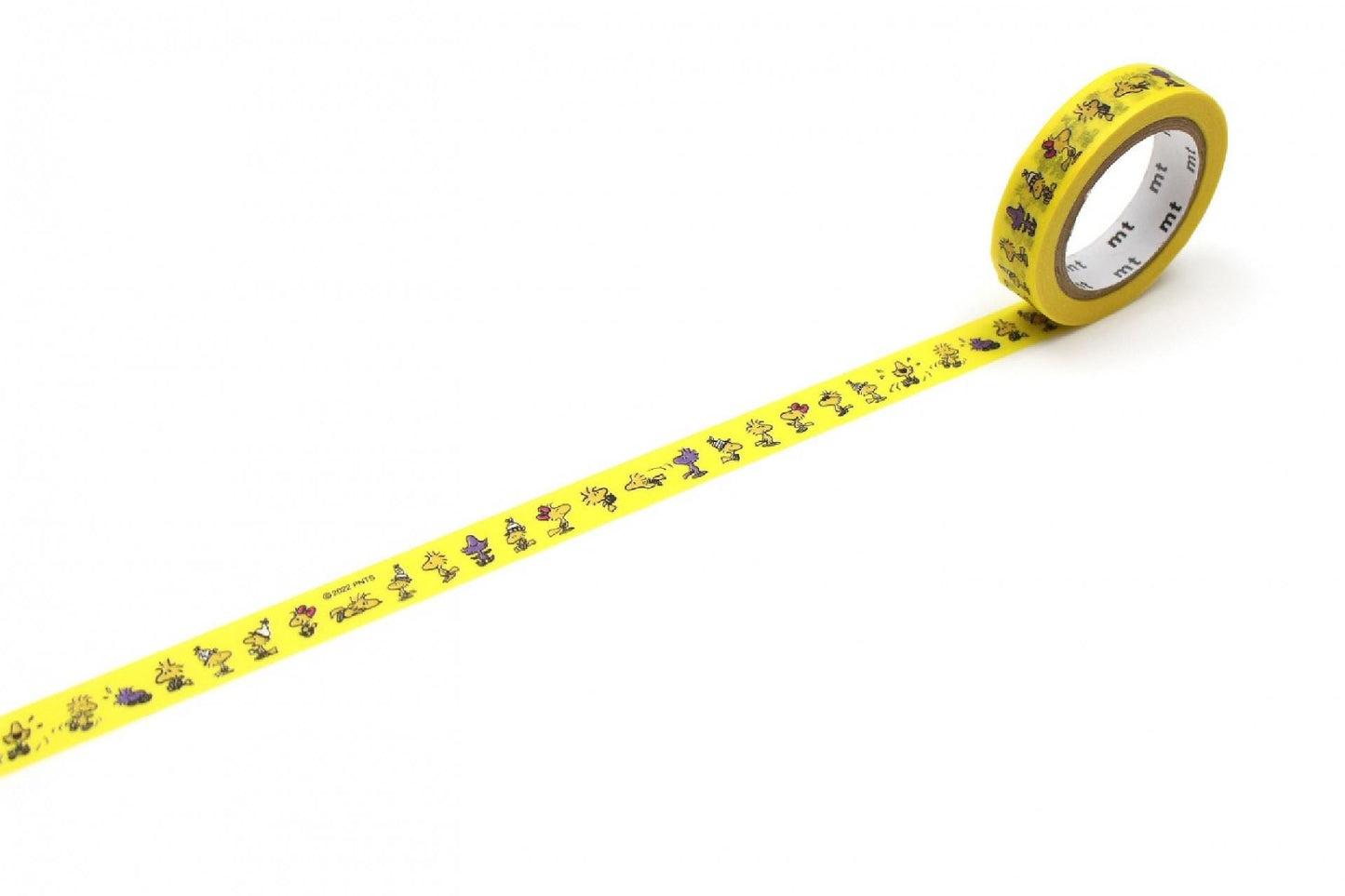 A yellow roll of tape with a repeating pattern of cartoon-like characters on it, lying on a white surface.