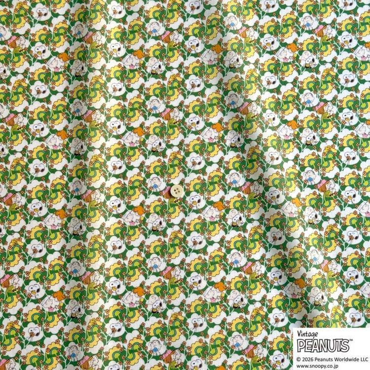 The image is a repeating pattern of cartoon-style faces and animals in various colors, including green, yellow, and white, creating a vibrant and playful design.