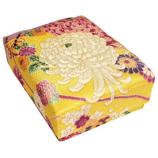 a square-shaped box with a vibrant, colorful floral pattern on its surface.