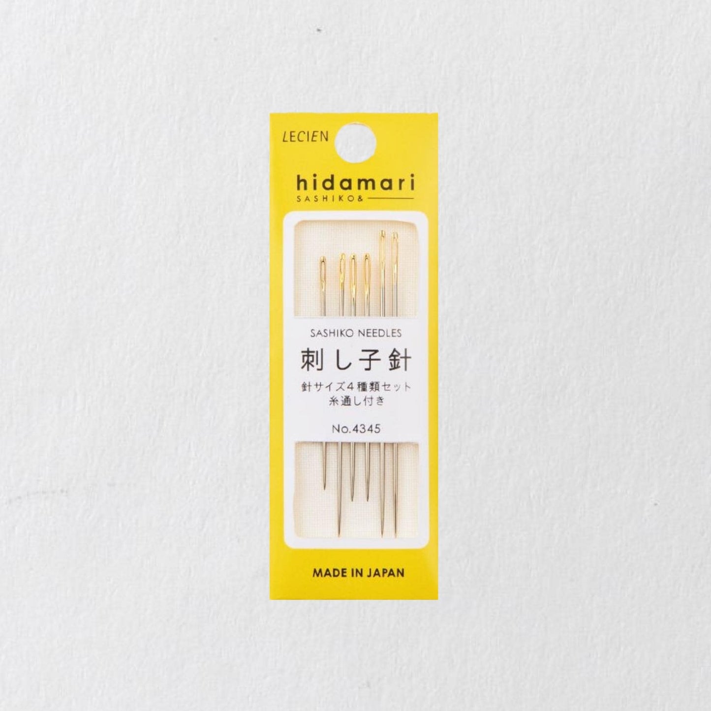 A yellow and white package containing a set of sewing needles, labeled as "Hidamari Sashiko & Sashiko" and "Made in Japan".