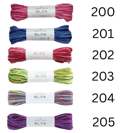 six spools of yarn with different colors, each labeled with a number.