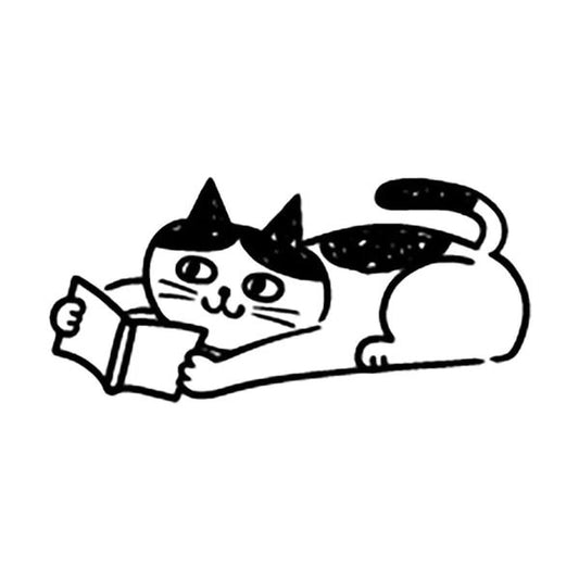 A black and white illustration of a cat lying down and reading a book.