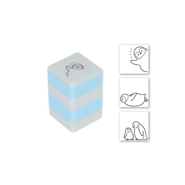 a blue and white cube-shaped object with a cartoon penguin design on it. There are also three smaller images of penguins, including one of a penguin standing upright and two penguins lying down.