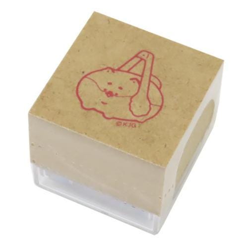 A square rubber stamp with a red illustration of a cat on it.