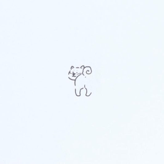 A simple line drawing of a small bear.