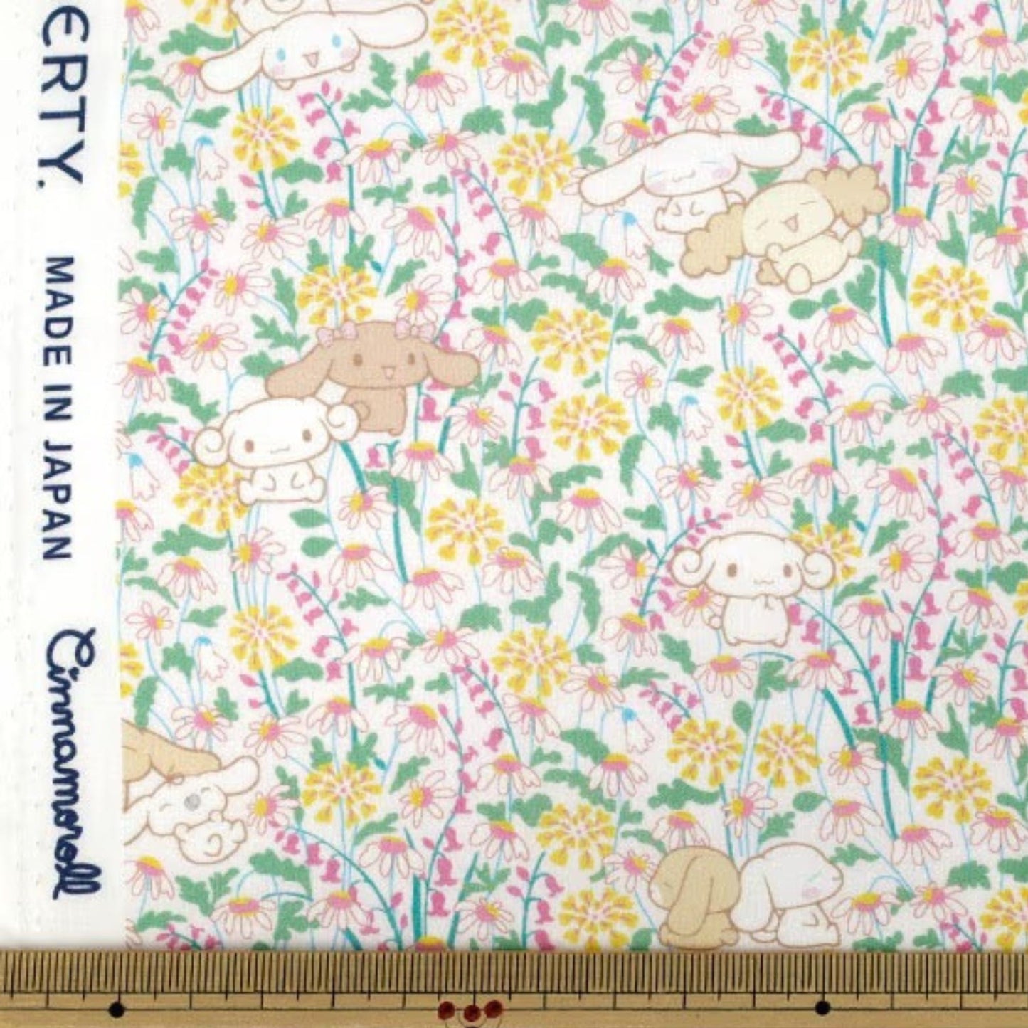 a pattern of cartoon-style animals, including rabbits, flowers, and other small creatures, arranged in a floral design.