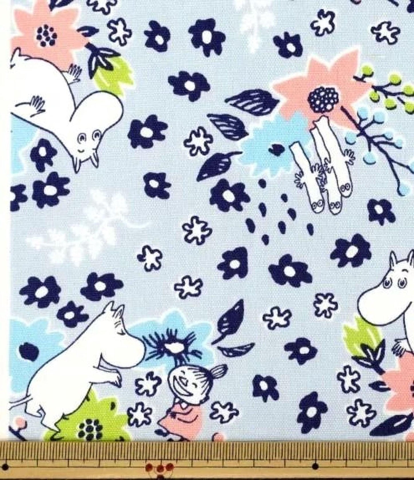 a fabric with a whimsical, cartoon-like pattern of Moom and Minnie Mouse characters surrounded by various floral and leaf motifs.