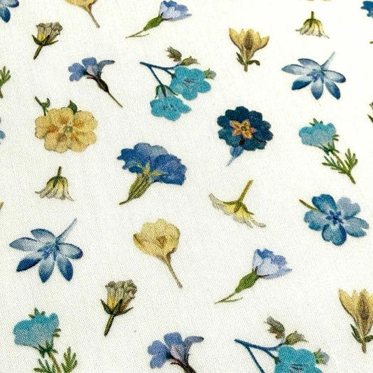 a variety of colorful flowers, including yellow, blue, and white flowers, arranged in a pattern on a white background.