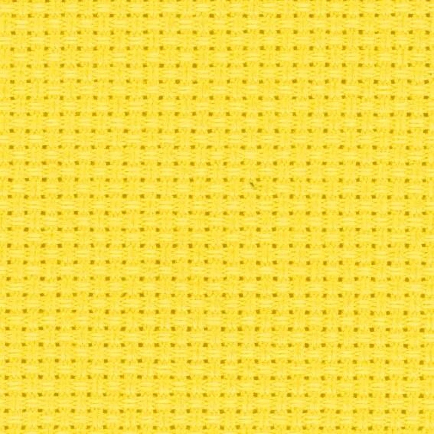 The image is a close-up of a yellow fabric with a grid-like pattern, which appears to be a cross-stitch design.