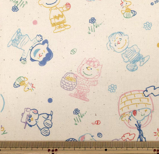 The image is a collage of various cartoon characters and illustrations, including Peanuts characters, on a fabric with a white background.