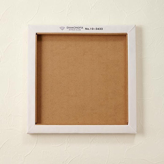 A white square frame with a blank canvas inside, mounted on a white wall.