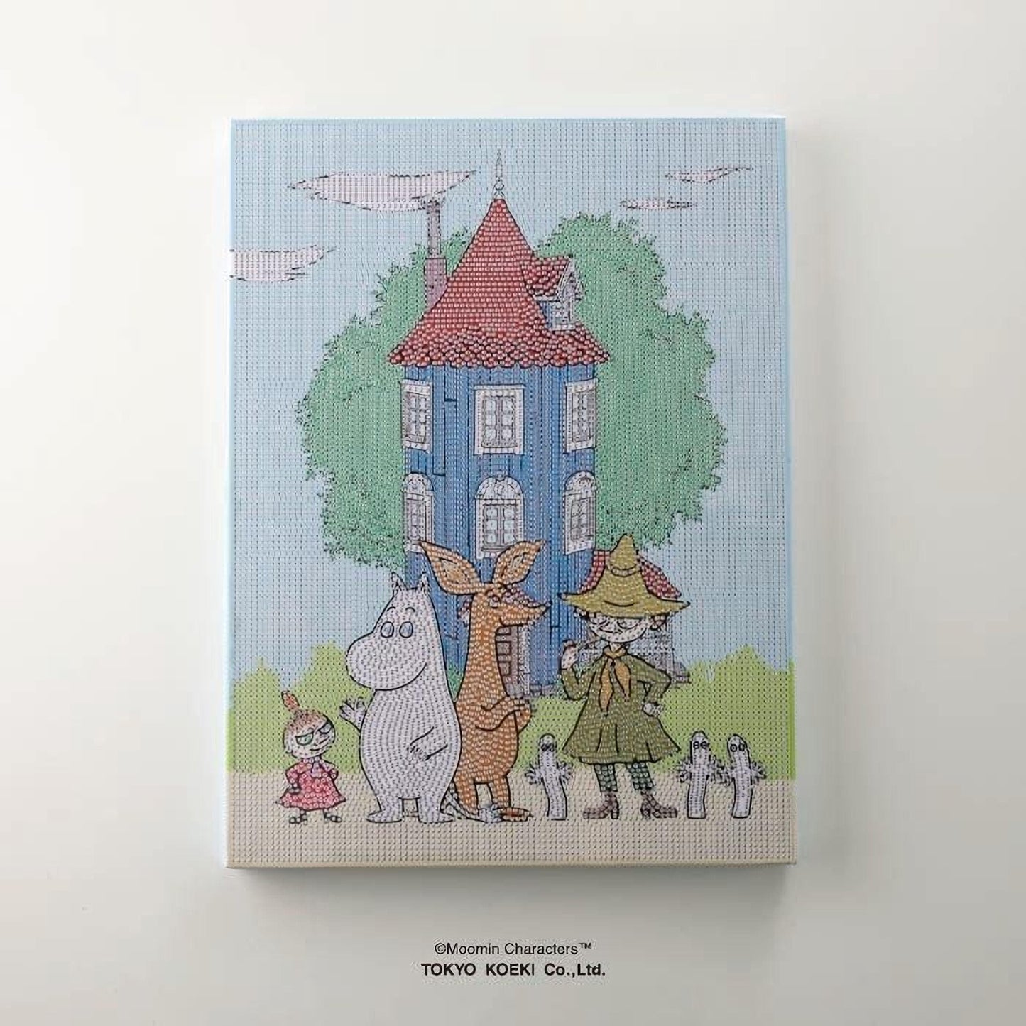 The image is a colorful illustration depicting a whimsical scene with various characters, including a house, a tree, and a group of people, all set against a blue background.