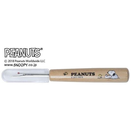 A Peanuts-themed sewing tool with a wooden handle and a cartoon image of the Peanuts characters on it.