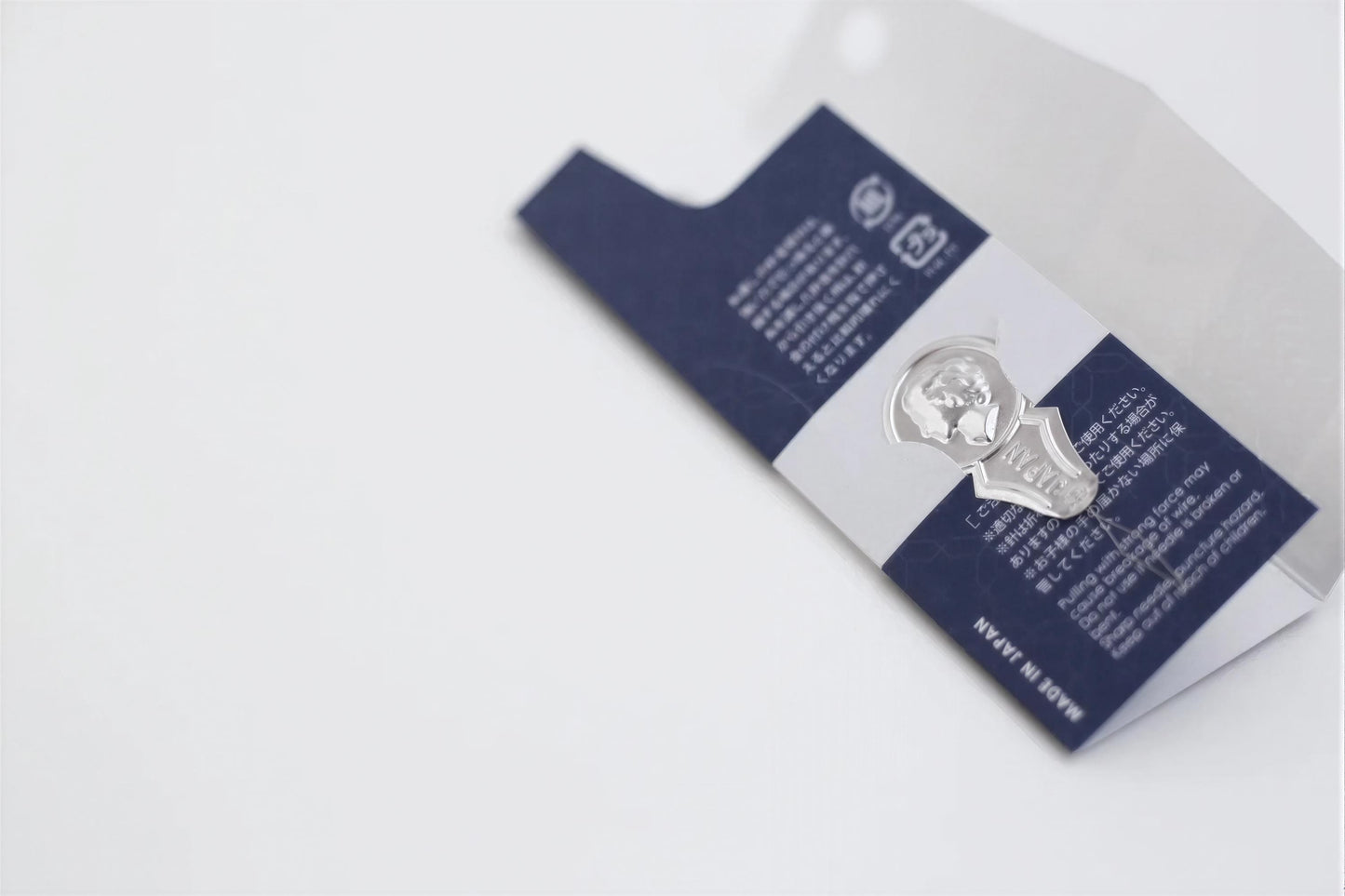a close-up view of a blue and white label with text and a silver emblem.