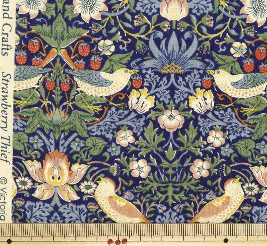 The image is a close-up of a fabric with a detailed floral and bird motif. The fabric features a variety of flowers, leaves, and birds in different colors and sizes, creating a vibrant and intricate pattern. The fabric appears to be a hand-woven textile, showcasing the craftsmanship and artistry involved in its creation.