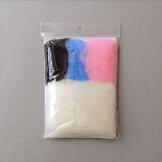 A clear plastic bag containing three different colored balls, including white, black, and pink.
