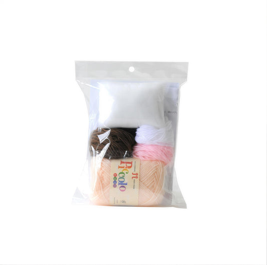 A clear plastic bag containing various yarn colors, including white, brown, and pink, along with a label that reads "Ricolo".