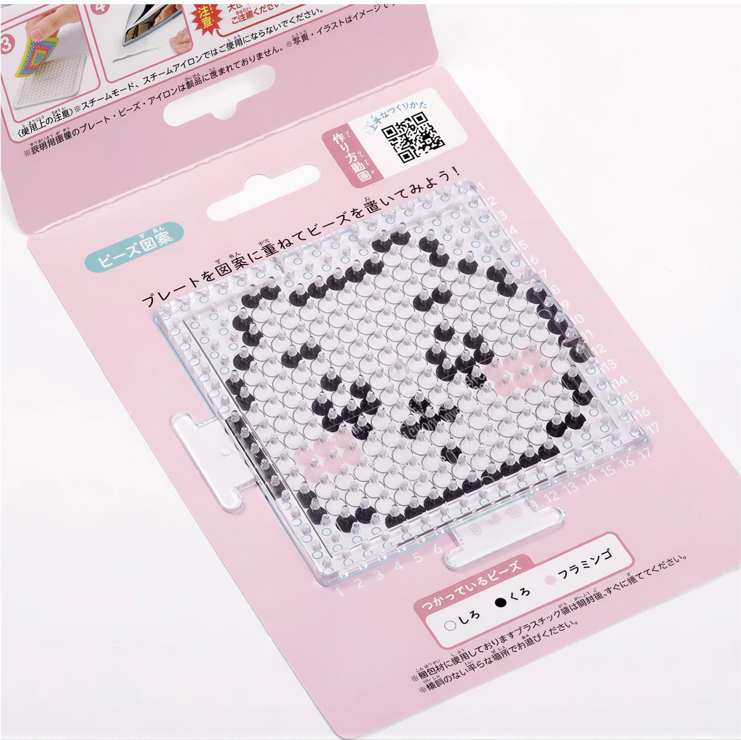 a pink packaging with a clear plastic window, displaying a pixelated character or design. The packaging appears to be a product or tutorial related to pixel art or digital design.