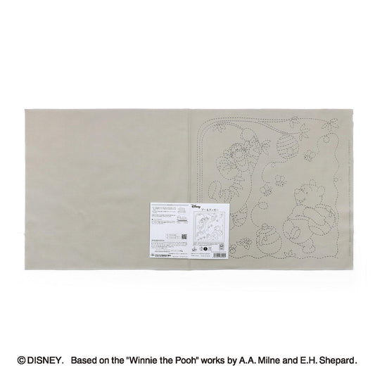 The image is a page from a book or magazine featuring a page with a drawing of Winnie the Pooh and a label with text.