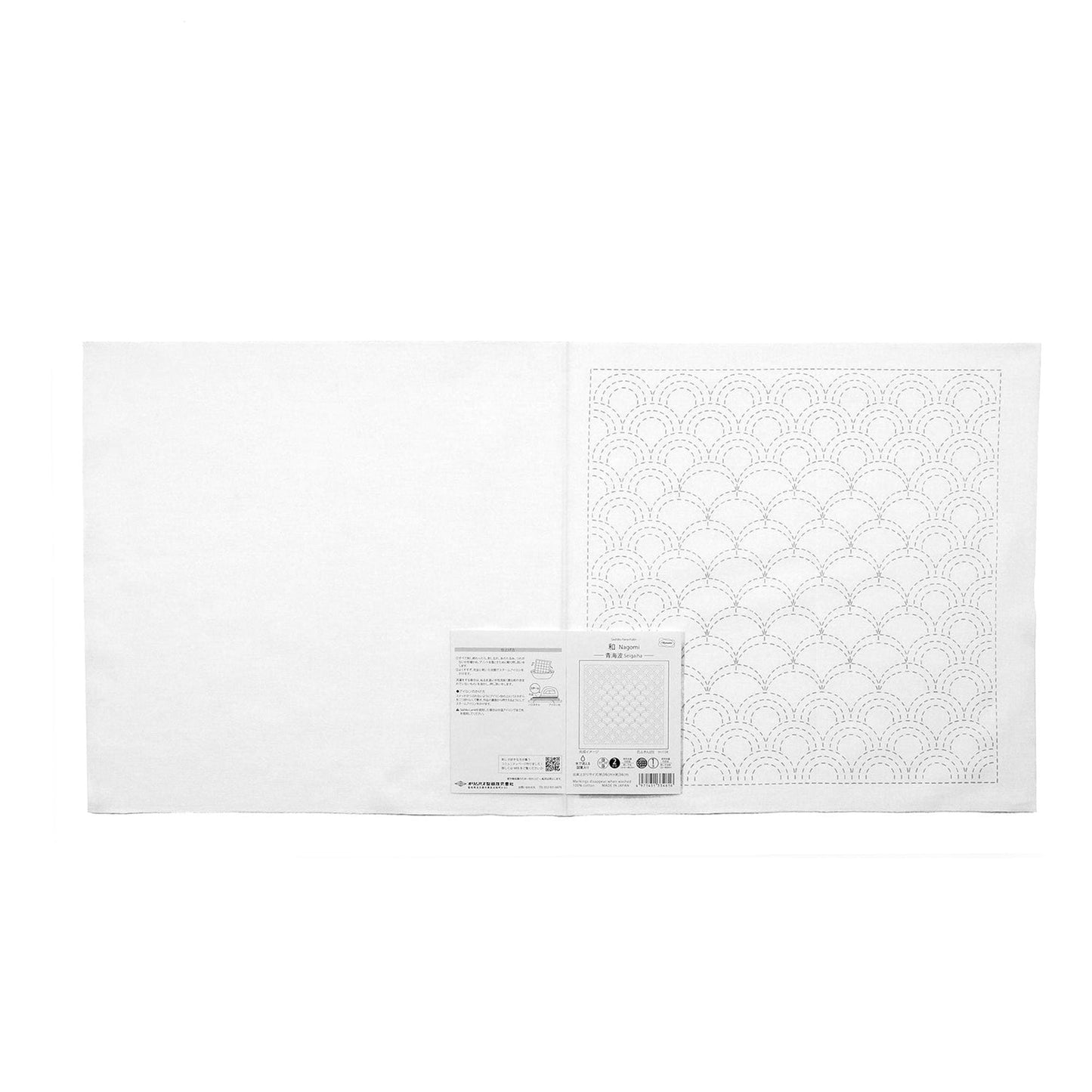 The image is a white square with a pattern of circles on it, and there is a small white paper with text next to it.