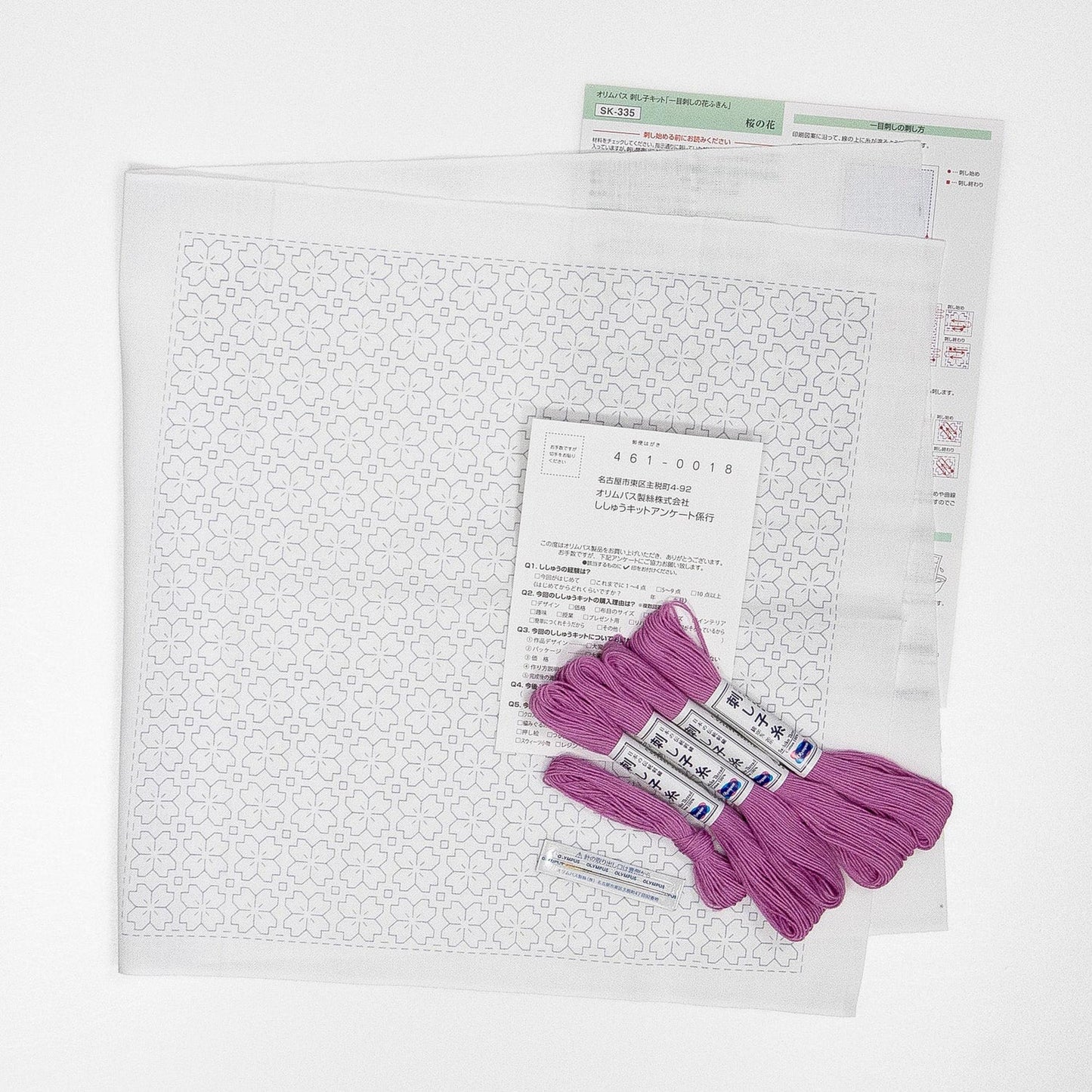 a sewing kit with a pattern, several spools of thread in a vibrant shade of purple, and some instructions or labels.
