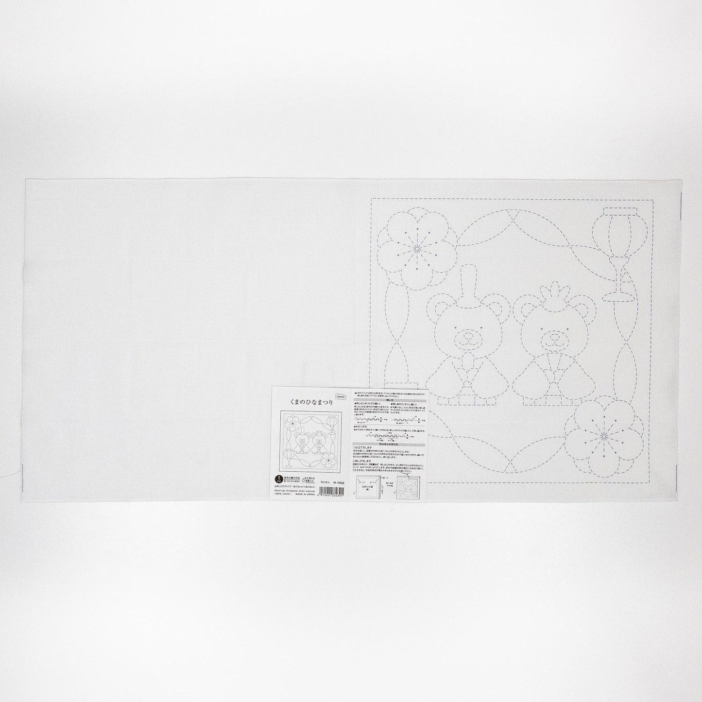 The image is a white sheet of paper with a black and white line drawing of two teddy bears and some flowers.