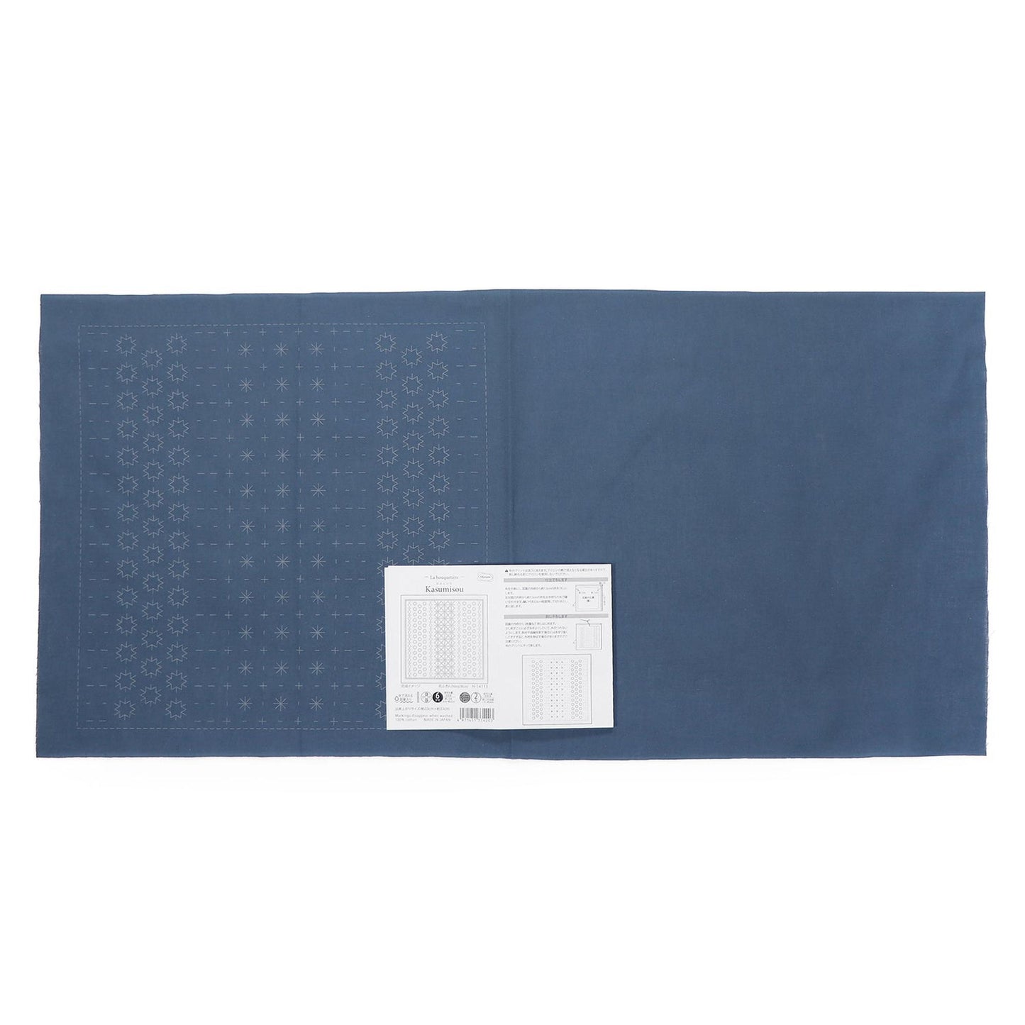 The image is a blue fabric with a white label placed on it.